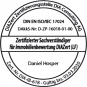 Circular seal badge with decorative border and a horizontal banner across the middle; text is illegible, suggesting an official stamp of authenticity.